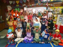 Picture of students wearing costumes and holding the book to match